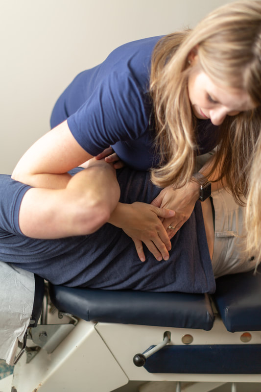 Dr. Kelley McVarish adjusting a patient's low back. 